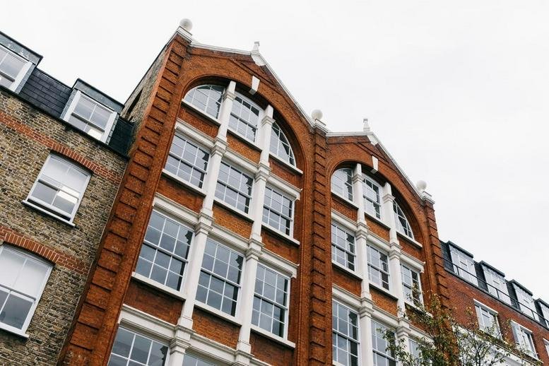 Red brick exterior of the Victorian style building at 18 Farringdon Lane.