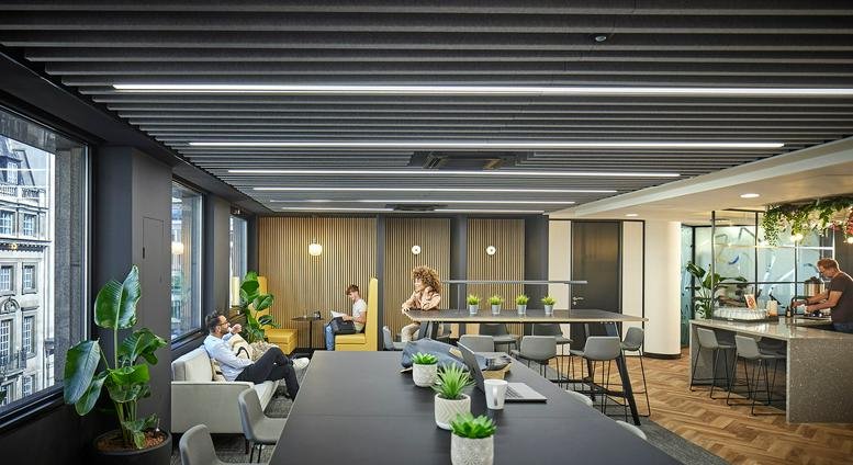 Spacious communal lounge at 18 King William Street, London featuring sleek slatted ceilings and city views.