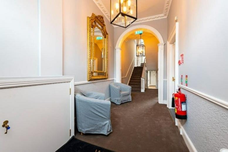 Grand entrance hallway at 19-22 Lower Baggot Street featuring a gold mirror and vaulted archway.
