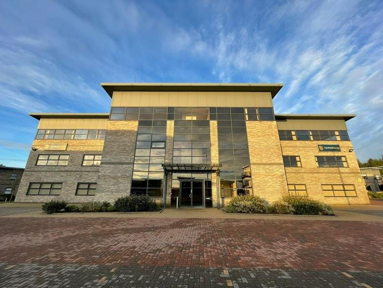 Exterior view of the modern stone and glass facade of 19, Abercrombie Court, Westhill, Aberdeenshire.