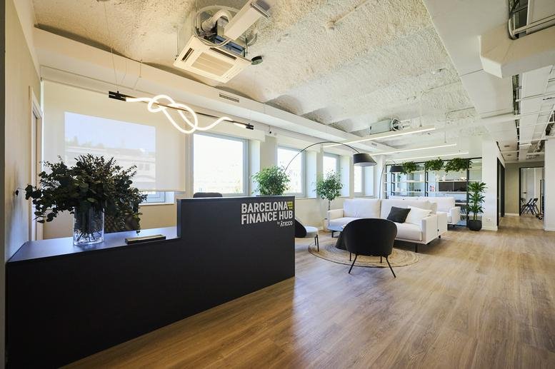 Lobby at 19, Passeig de Gràcia, Barcelona featuring a black reception desk and modern lounge furniture.