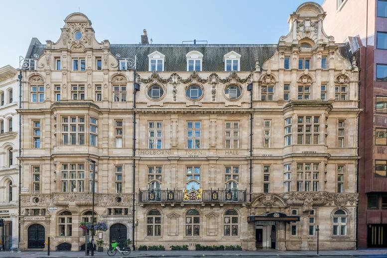 Grand stone facade of 193-197 High Holborn, Holborn Town Hall, London featuring ornate architectural carvings.
