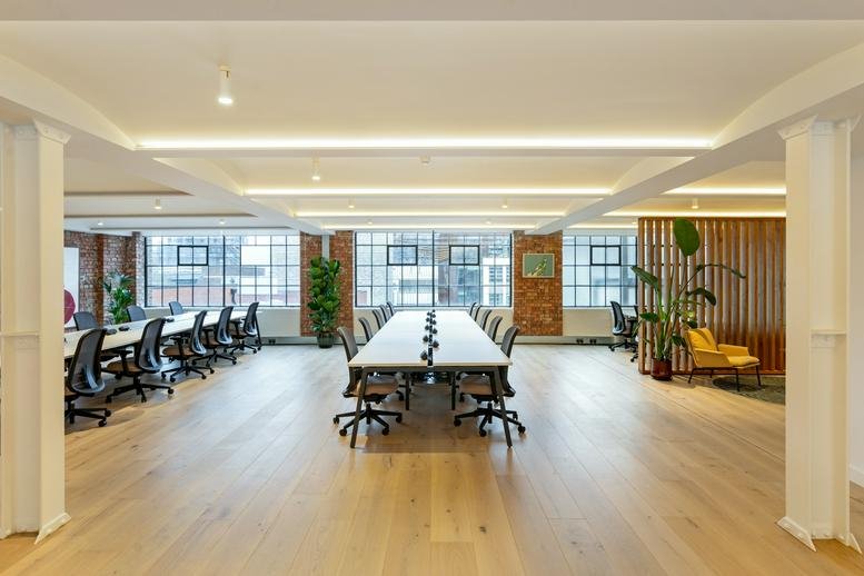 Spacious open-plan workspace at 195-205, Union Street, London with wooden floors and rows of desks.
