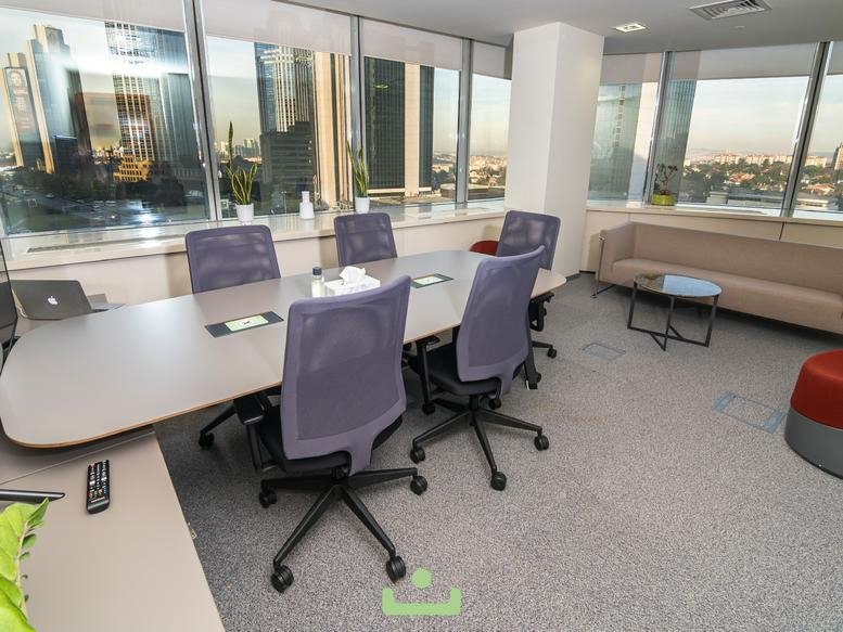 Spacious boardroom with purple mesh chairs and views of the Istanbul skyline.