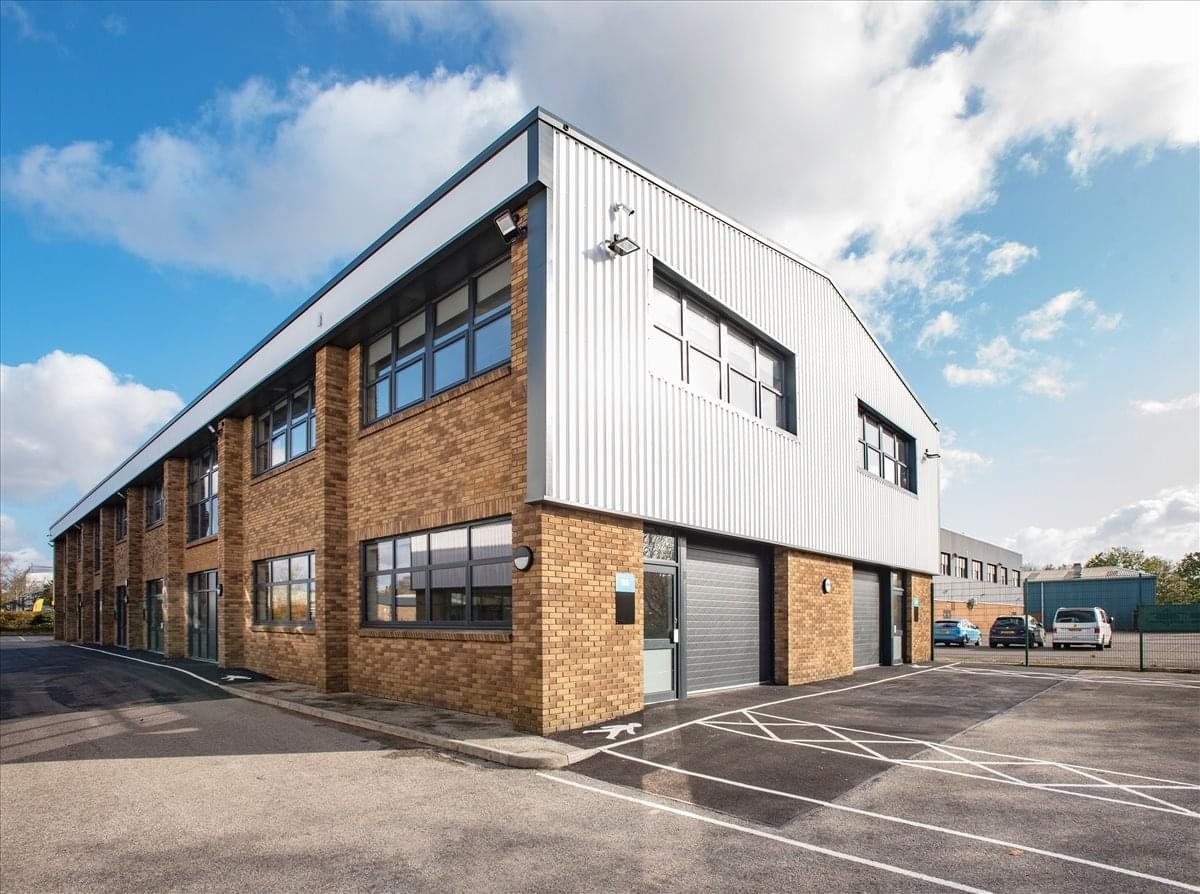 Industrial-style exterior of Aerodrome Studios at 2-8 Airfield Way with brick facade and parking.