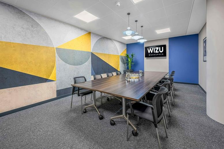 Spacious boardroom at 2 West Regent Street featuring a colorful geometric mural and modern lighting.