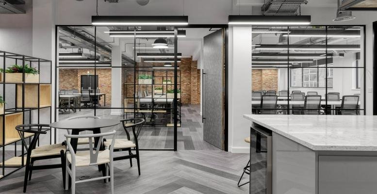 Spacious open-plan common area at 20 Baltic Street with glass partitions and modern seating.