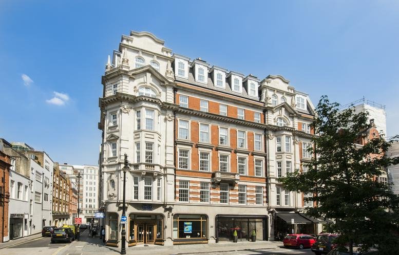 Exterior of the historic grand stone and red brick building at 20 North Audley Street.