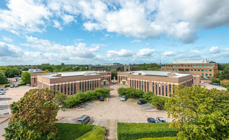 Exterior view of the brick facade and landscaped grounds at 200 Aztec West, Bristol.