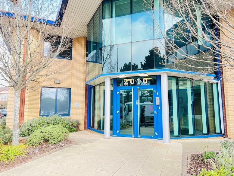 Exterior view of the contemporary glass and brick entrance at 2010 The Crescent, Solihull Parkway.