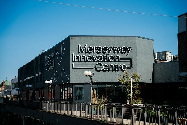 Exterior view of Merseyway Innovation Centre featuring a grey facade with bold signage.