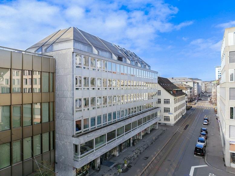 Street-level view of the modern stone facade of 21 Talacker, Paradeplatz, Zurich.