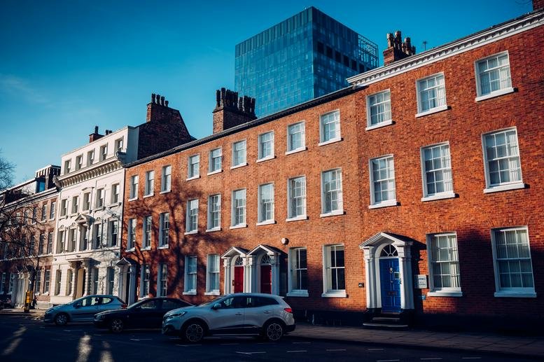 Exterior view of the historic red brick facade at 22 St John Street, Manchester.