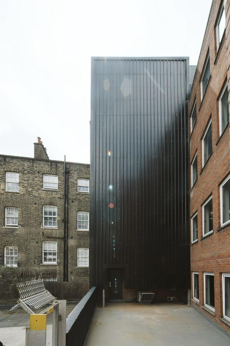 Modern exterior view of the dark ribbed facade at 222 Bishopsgate, London.