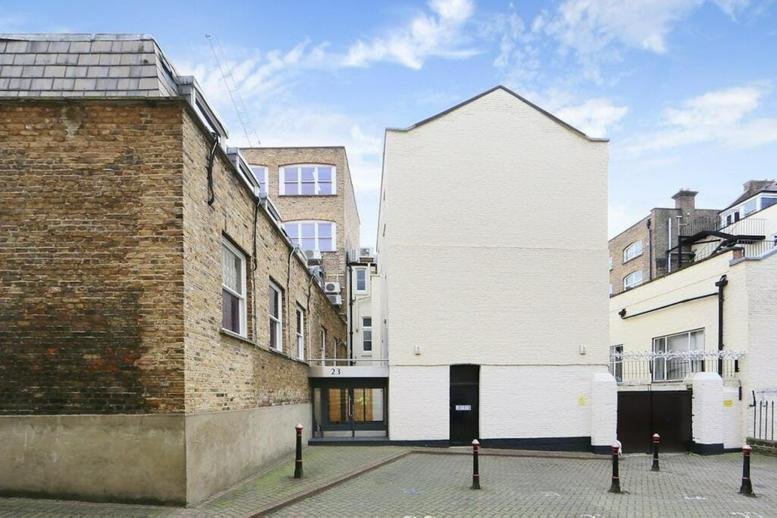 Exterior view of the brick and white facade building at 23, Clerkenwell Close, London.