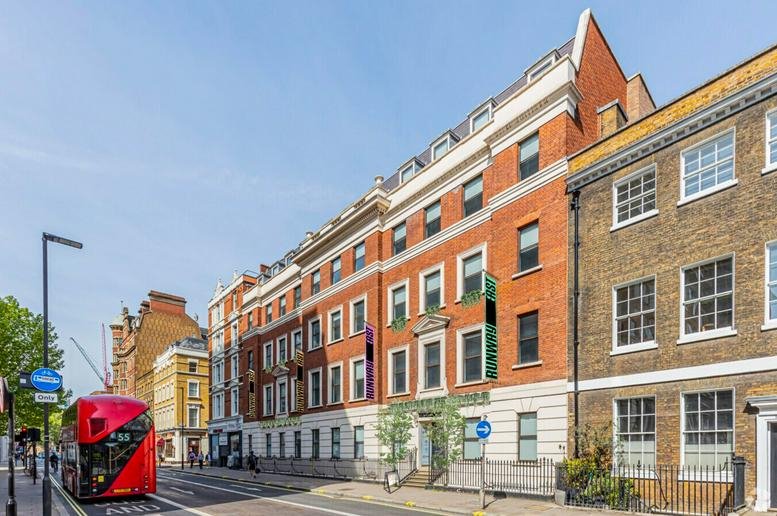Exterior view of the red brick and stone facade of 24-28 Bloomsbury Way, Central London.