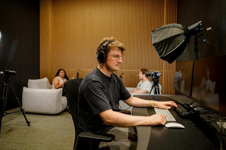 Professional recording or podcast studio with microphones, soundproofing, and video equipment.