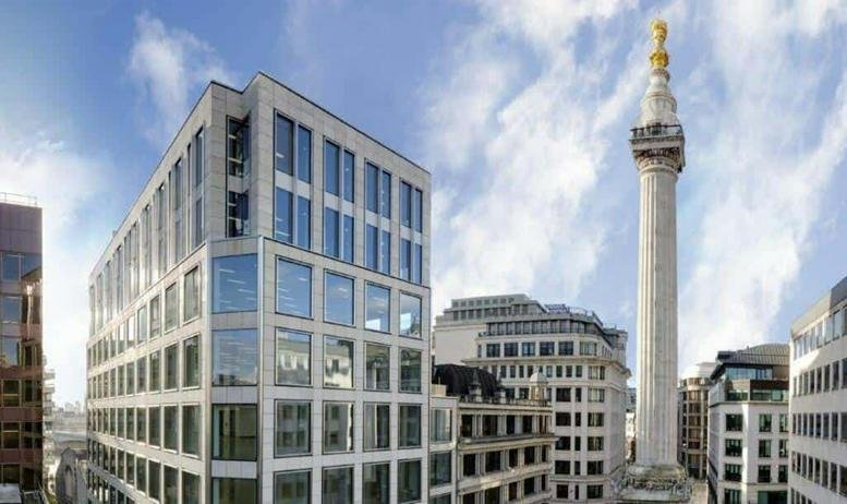 Exterior view of the contemporary facade at 24 Monument Street beside the historic Monument column.