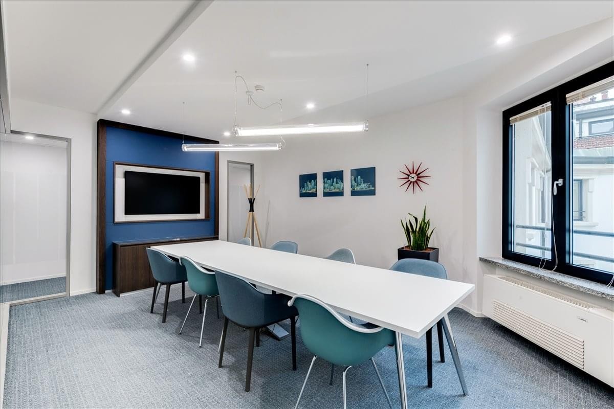 Modern conference room at 24 O’Connell Street, Waterford with a blue feature wall and white meeting table.