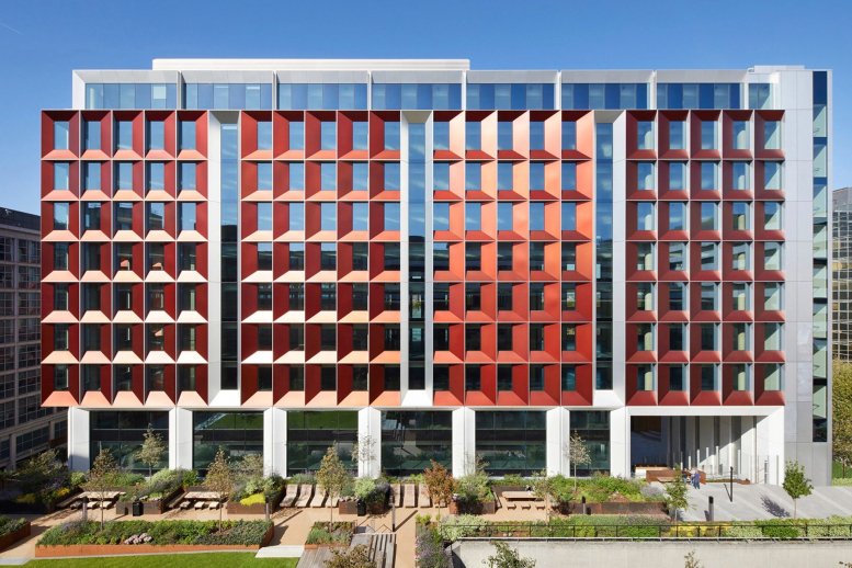 Exterior view of the striking red and glass facade at 245 Hammersmith Road, London.