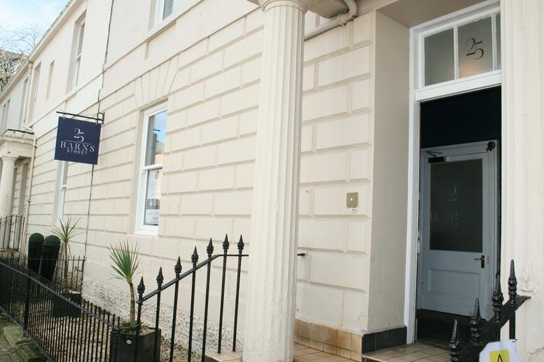 Exterior view of the white stone facade and entrance at 25 Barns Street.