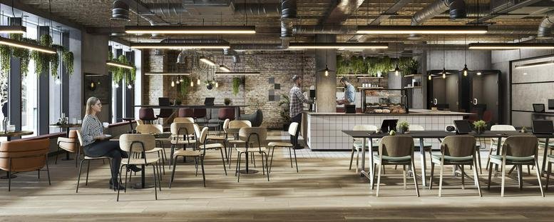 Spacious communal lounge and kitchen area with modern seating and exposed ductwork.