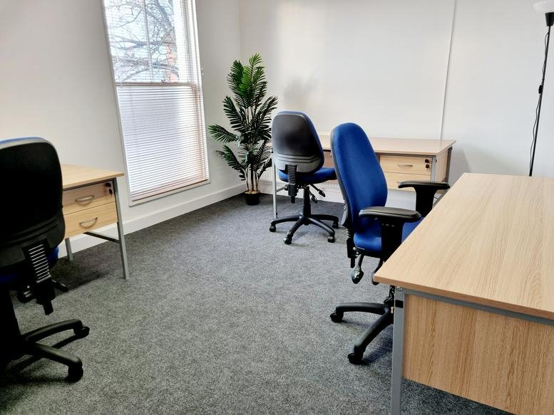 Three-person office suite at 27-28 Windmill Street, Paro Business Centre with natural light and a green plant.