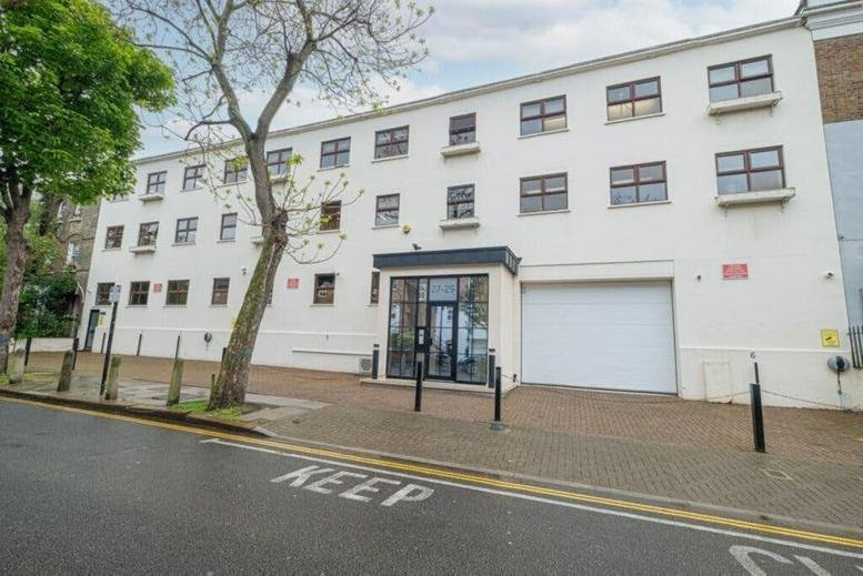 Exterior view of the white facade and entrance at 27-29, Vauxhall Grove, London.