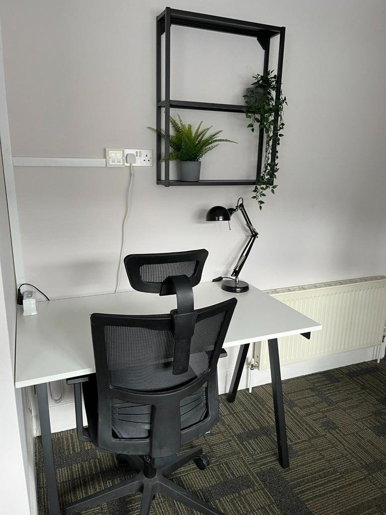 Private office space at 28-30 Barden Road, Tonbridge, Kent, United Kingdom with a white desk and shelving.