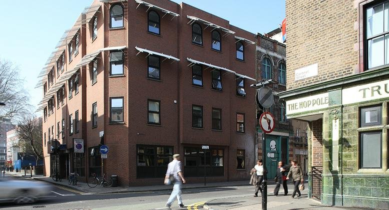 Exterior view of the brick facade and street corner at 28 Charles Square, London.