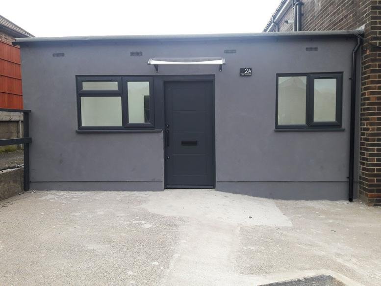 Exterior view of the grey rendered office building at 2A High Moor Drive.