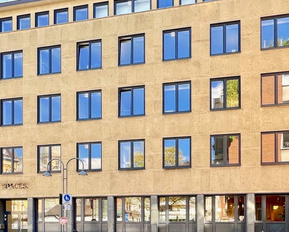 Exterior view of the sandstone building at Gertrudenstr. 30-36 featuring a classic window facade.