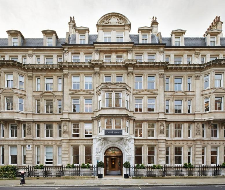 Grand stone facade of the historic 3-7 Temple Avenue building featuring arched entrance and ornate masonry.