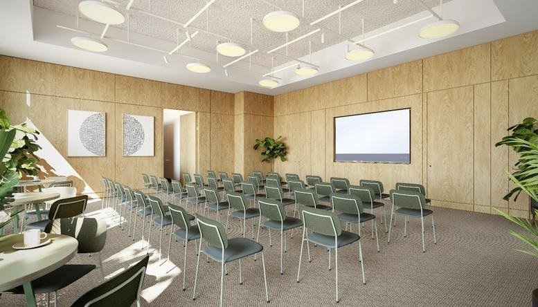 Spacious wood-paneled seminar room at 3 New Street Square with theater-style seating and projector screen.