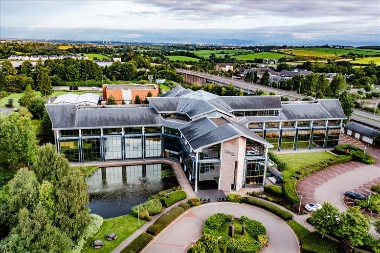 Wide-angle exterior shot of a contemporary office building with reflective glass panels.