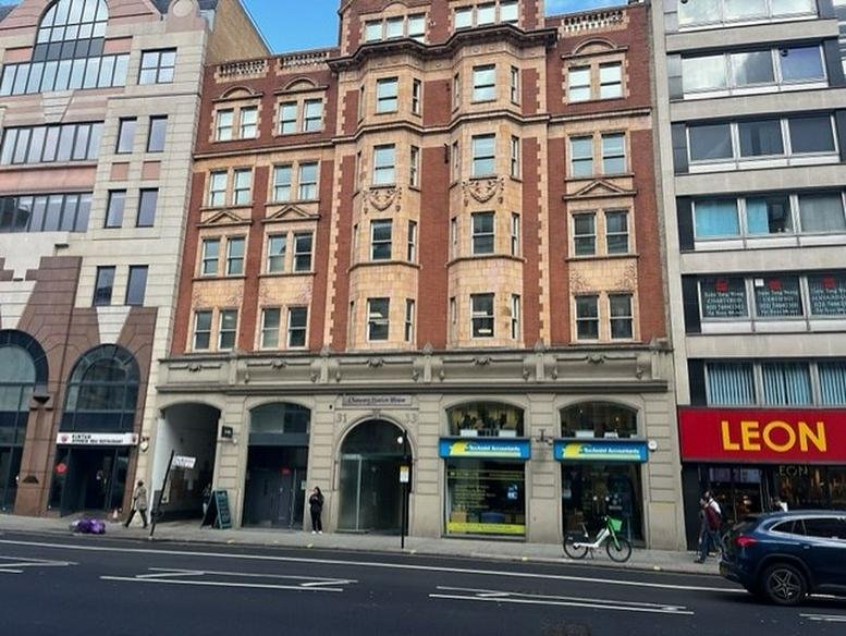 Brick facade of 31-33 High Holborn, Chancery Station House, featuring traditional architecture and street-level shops.