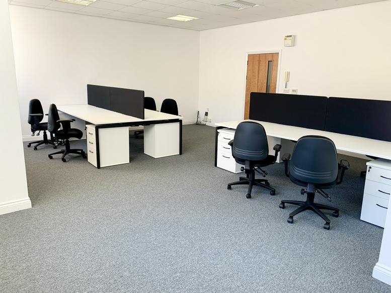 Spacious open-plan office with white desks, ergonomic chairs, and natural light at 31 Bootham.