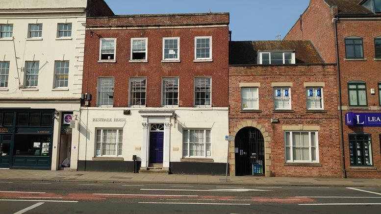 Exterior street-level view of the brick and white facade at 32-33, Foregate Street, Worcester.
