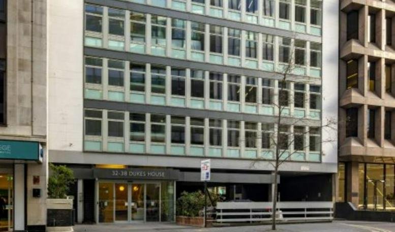 Exterior view of the multi-story glass and stone facade at 32-38, Dukes Place.