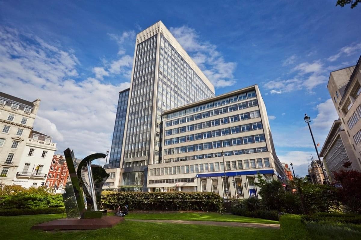 Exterior view of the white high-rise facade at 33 Cavendish Square.