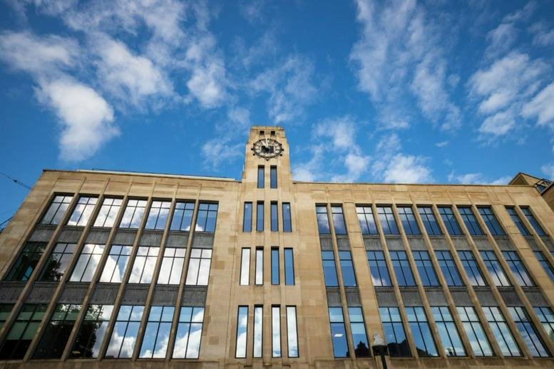 Wide view of the 33 Colston Avenue building facade with its distinctive clock tower.