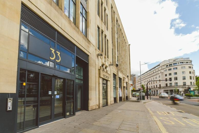 Exterior view of the stone facade entrance at 33 Colston Avenue, Bristol.