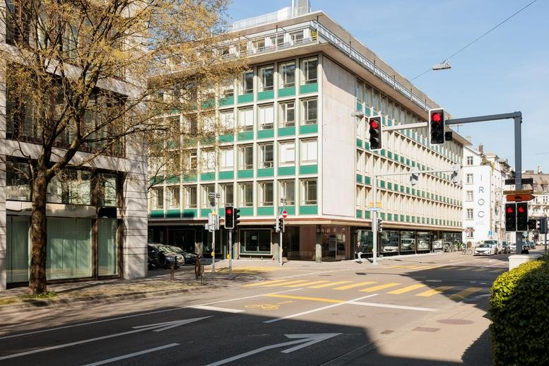 Exterior view of the green-accented building facade at 33, Stockerstrasse, Zurich.