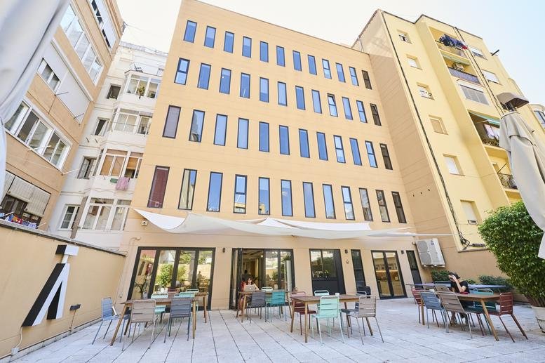 Exterior view of the multi-story yellow brick building at 339, Carrer de Provença, Barcelona.