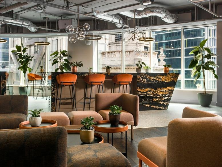 Sophisticated lounge area at 34-37 Liverpool Street with marble-topped bar and plush armchairs.