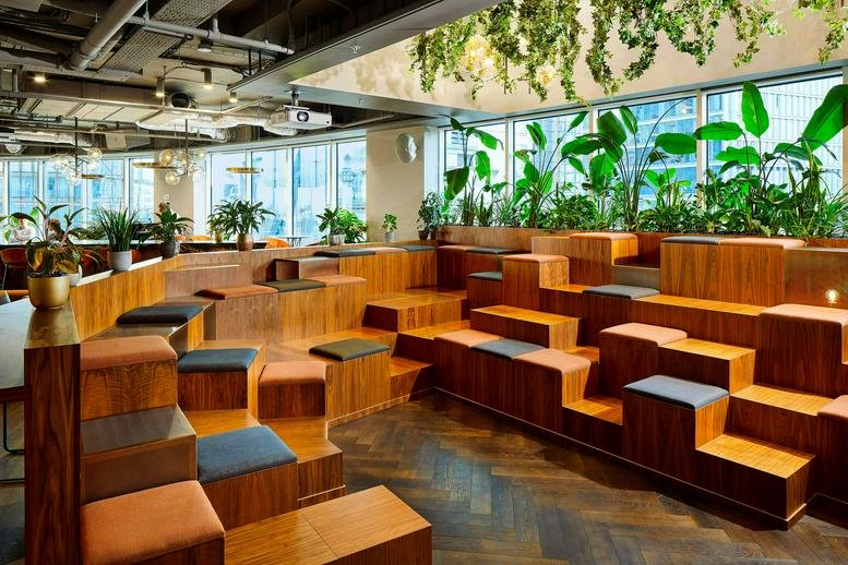 Expansive tiered lounge at 34-37 Liverpool Street with integrated greenery and natural light.