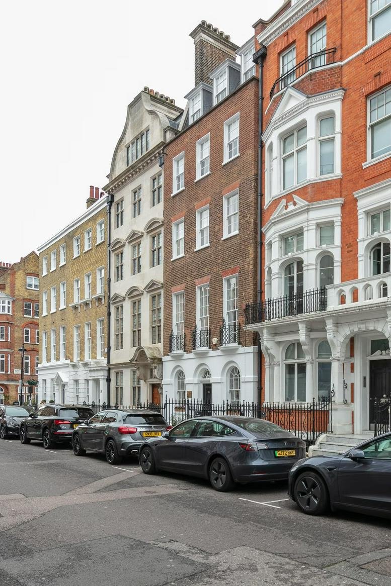 Exterior view of the traditional brick and white stone facade of 34 Queen Anne Street.