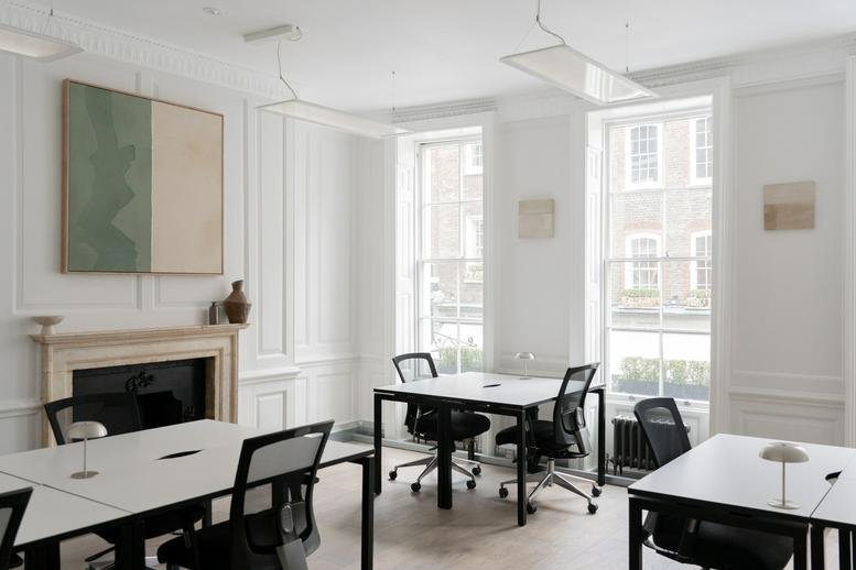 Spacious team office at 34 Tavistock Street with period features, a fireplace, and multiple workstations.