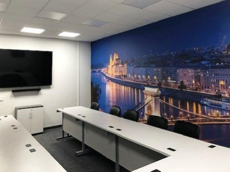 Meeting room at 34 West Street, Rochford, Essex featuring a large city skyline mural and a long conference table.