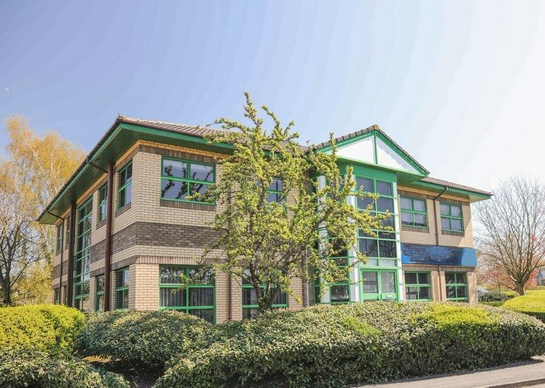 Exterior view of the brick and glass office building at 35 Duncan Close, Moulton Park.